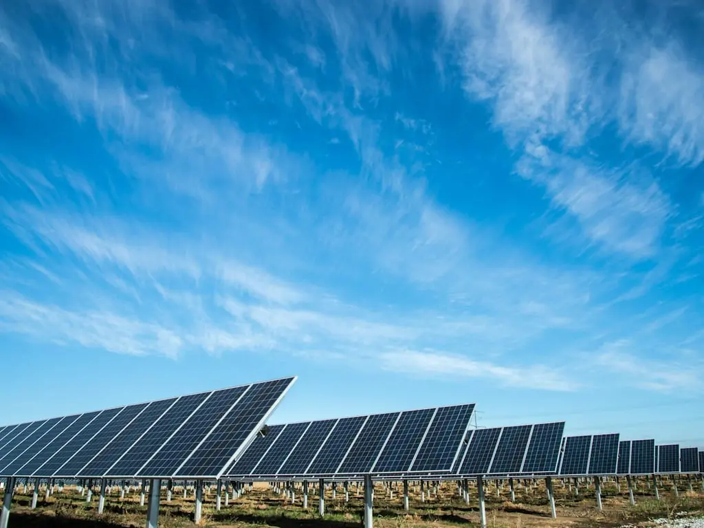 Rows of solar panels under a blue sky